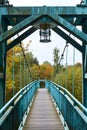 Bridge over the river. Bridge in the forest. Crossing the water in the countryside. Metal bridge for people in rural areas through Royalty Free Stock Photo