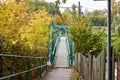 Bridge over the river. Bridge in the forest. Crossing the water in the countryside. Metal bridge for people in rural areas through Royalty Free Stock Photo