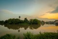 Bridge over the river with green forest after sunset