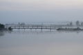 Bridge over river in morning in fog