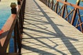 Bridge over the river in a park concrete floor wooden rail blue sky reflects down the river Royalty Free Stock Photo