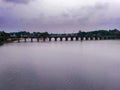 A Bridge over river and thunder clouds in sky. Royalty Free Stock Photo