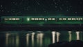 bridge over river A train that moves over a river along a bridge in a starry night. The train is black and green, Royalty Free Stock Photo