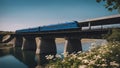 bridge over river A train that travels over a bridge across a river in a sunny evening. The train is black and blue