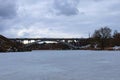 Bridge over Ros River in Bila Tserkva. Winter landscape view of frozen river in cloudy day. Bila Tserkva, Ukraine Royalty Free Stock Photo