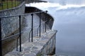 Bridge over safety spillway of the dam. stone bridge with natural paving of gray flat stones. on the edge of the retaining walls i Royalty Free Stock Photo