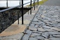 Bridge over safety spillway of the dam. stone bridge with natural paving of gray flat stones. on the edge of the retaining walls i Royalty Free Stock Photo