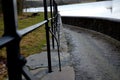 Bridge over safety spillway of the dam. stone bridge with natural paving of gray flat stones. on the edge of the retaining walls i Royalty Free Stock Photo