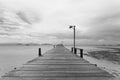 Bridge over the sea during ebb tide in black and white Royalty Free Stock Photo