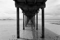 Bridge over the sea during ebb tide in black and white Royalty Free Stock Photo