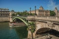 Bridge over the Seine River and the Conciergerie building with sunny blue sky at Paris. Royalty Free Stock Photo