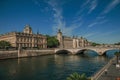 Bridge over the Seine River and the Conciergerie building with sunny blue sky at Paris. Royalty Free Stock Photo