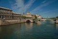 Bridge over the Seine River and the Conciergerie building with sunny blue sky at Paris. Royalty Free Stock Photo