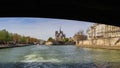 The bridge over Seine river frames Notre Dame Cathedral. Before the fire. April 05, 2019. Paris France Royalty Free Stock Photo