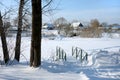 A bridge over a small creek, winter in the village, the ground under the snow. Royalty Free Stock Photo