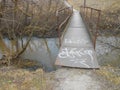 Bridge over the small river in spring. Royalty Free Stock Photo