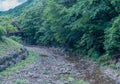 Bridge over small rocky stream in recreational forest park Royalty Free Stock Photo