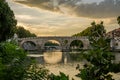 Bridge over the Tiber River at sunset on a summer evening in Rome, Italy Royalty Free Stock Photo