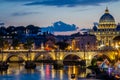 The bridge over the Tiber River and the Vatican dome at sunset in the evening in a summer day in Rome, Italy Royalty Free Stock Photo