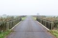 Bridge over water in a misty morning rural landscape in the Netherlands