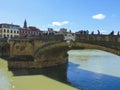 Bridge over the water with people walking in Florence, Italy