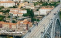 Bridge and pedestrians walking over old town houses and red tile roofs of historical buildings Royalty Free Stock Photo