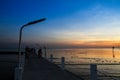 Bridge and pier with beautiful sunset twilight sky at the sea. Royalty Free Stock Photo