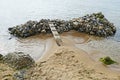 Bridge on a pile of rocks in the sea Royalty Free Stock Photo