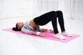 Bridge pose sporty woman doing warming up exercise for spine, backbend, arching stretching her back working out at home Royalty Free Stock Photo