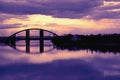 Bridge reflection in water surface of river Dnieper duaring sunset time.