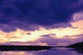 Bridge reflection in water surface of river Dnieper duaring sunset time.