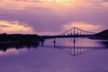 Bridge reflection in water surface of river Dnieper duaring sunset time. Royalty Free Stock Photo