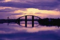 Bridge reflection in water surface of river Dnieper duaring sunset time. Royalty Free Stock Photo