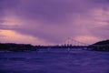 Bridge reflection in water surface of river Dnieper duaring sunset time. Royalty Free Stock Photo