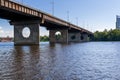 Bridge on a river against a blue sky and clouds Royalty Free Stock Photo