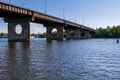 Bridge on a river against a blue sky and clouds Royalty Free Stock Photo