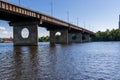 Bridge on a river against a blue sky and clouds Royalty Free Stock Photo