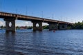 Bridge on a river against a blue sky and clouds Royalty Free Stock Photo