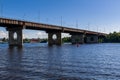 Bridge on a river against a blue sky and clouds Royalty Free Stock Photo