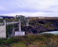 Bridge river cliff Iceland road houses