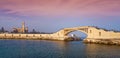 Bridge in the sea at Montazah park with the Royal palace in the far distance with calm sea at sunrise time, Alexandria, Egypt