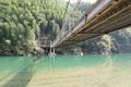 The bridge spanning over the clear and emerald water