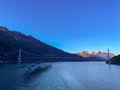 Bridge spanning a river, surrounded by majestic snow-capped mountains in the background Royalty Free Stock Photo