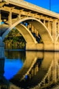 A bridge spans a river with a reflection of the bridge in the water Royalty Free Stock Photo