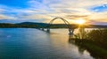 Bridge at sunset with blue skies over water connecting New York to Vermont