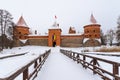 Bridge to the historical Trakai stone castle in winter, front view, Lithuania. Royalty Free Stock Photo