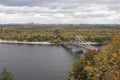A bridge to Trukhanov Island Kyiv, Ukraine over gray autumnal Dnipro river