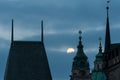 Bridge tower of Charles bridge in Prague over the Vlatva river at night with full moon in sky behind clouds Royalty Free Stock Photo