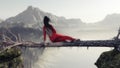 Woman sitting on fallen above a gap between mountain peaks .