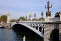 a bridge with two golden statues standing on one side of it